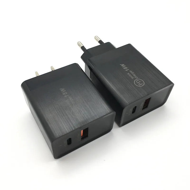 White 18W USB-C PD fast wall charger with US plug on a wooden surface.