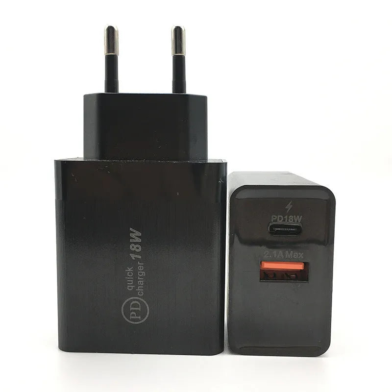 White 18W USB-C PD fast wall charger with US plug on a wooden surface.