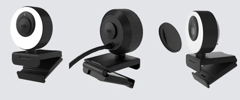 Black Full HD USB webcam with built-in microphone and magnetic privacy cover on a desk.
