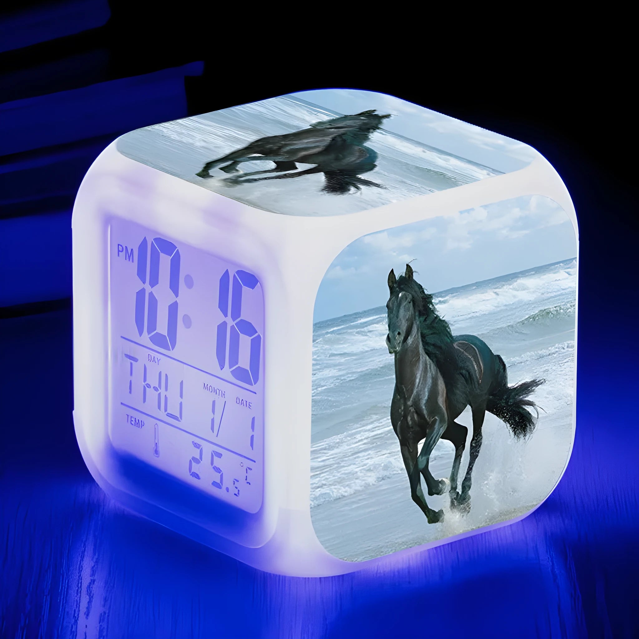Square cartoon-style LED digital alarm clock showing time and temperature on a desk.