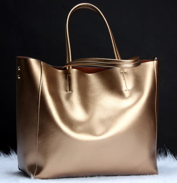 Women's cowhide leather shoulder bag in black with adjustable strap showing interior liner compartment