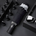 Black full automatic reverse umbrella open, showing 10-bone structure and plastic non-slip handle.