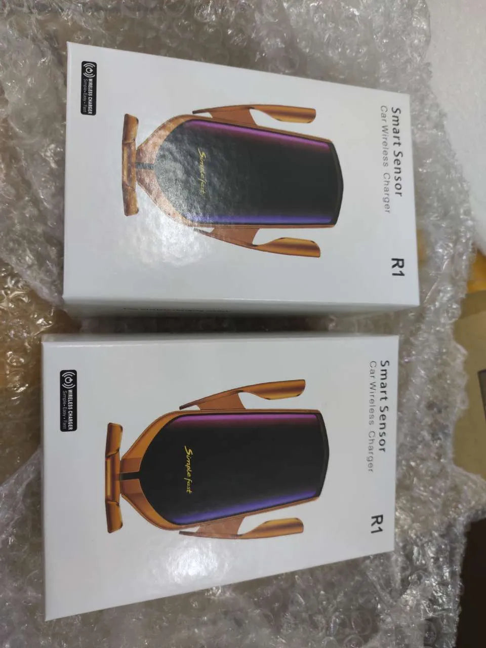 Magic Clip R1 automatic clamping car phone holder with wireless charging in gold and silver colour options.