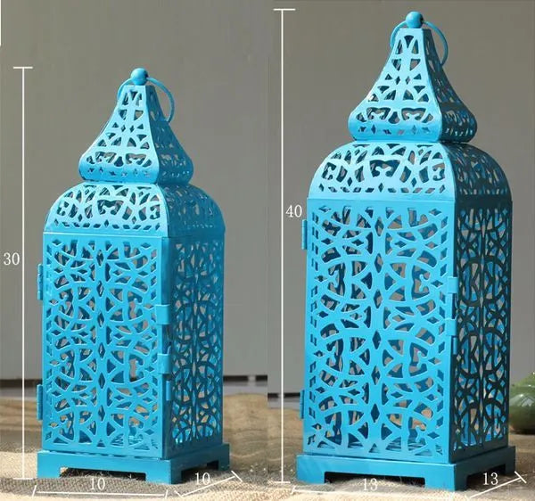 Blue geometric Moroccan-style metal candelabra with hollow design and hanging ornaments