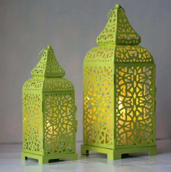 Blue geometric Moroccan-style metal candelabra with hollow design and hanging ornaments