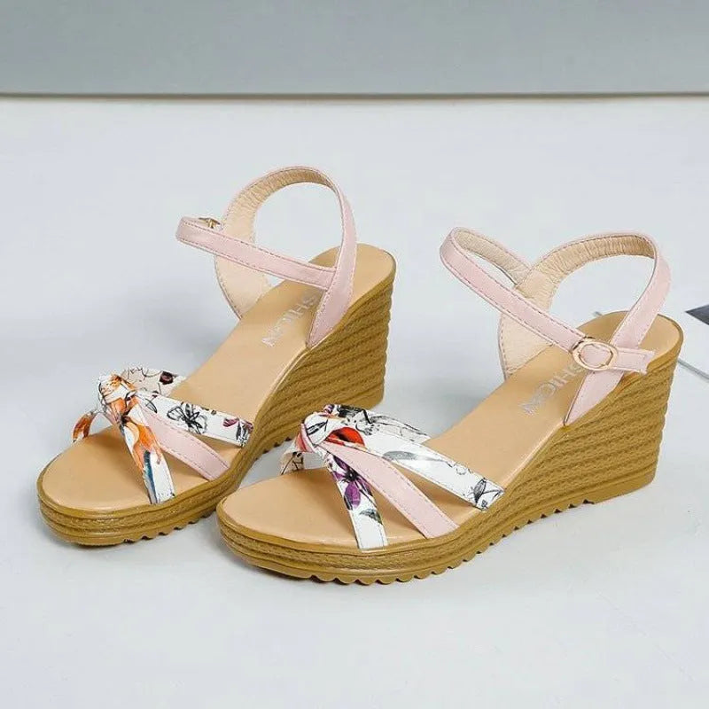 Women's pink wedge sandals with a fish mouth opening and buckle strap on a non-slip PU sole.