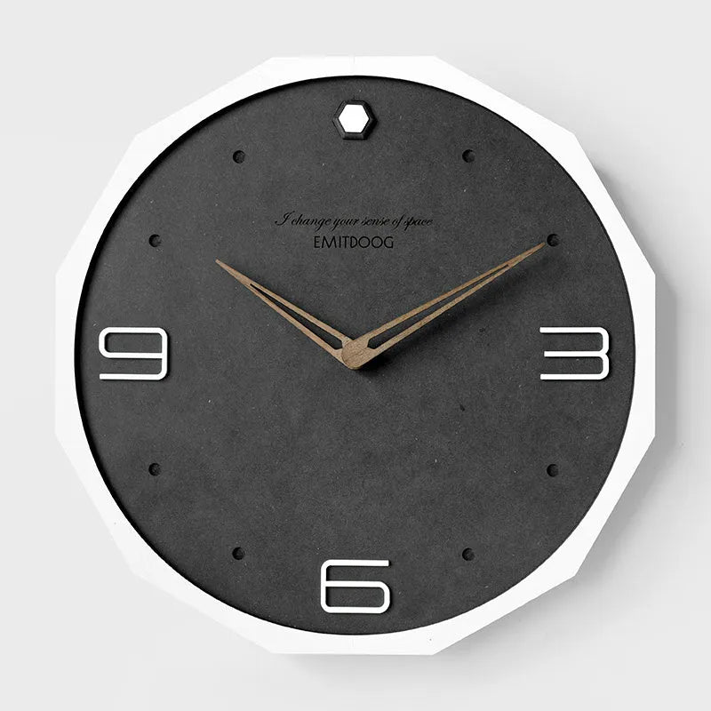 Round 12 inch Nordic minimalist wall clock with wooden frame on a light-coloured wall.