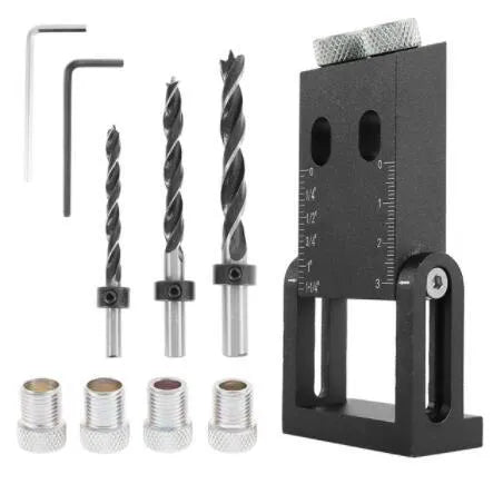 Black aluminium woodworking perforation locator tool with drill bits on a wooden surface