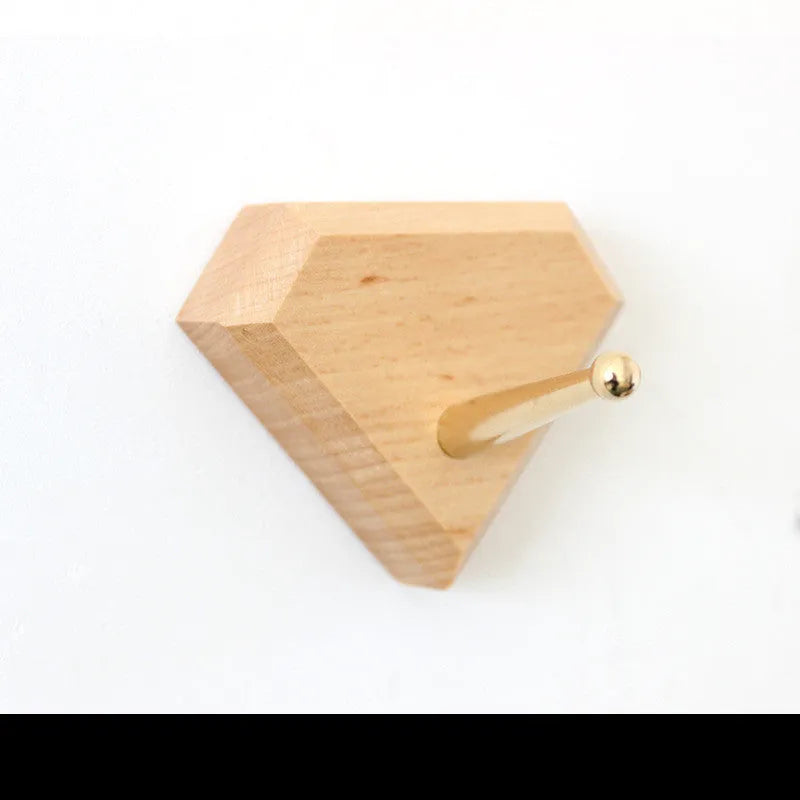 Beech wood adhesive wall hook with brass finish in capsule shape, shown next to round, oval, diamond and square variants.