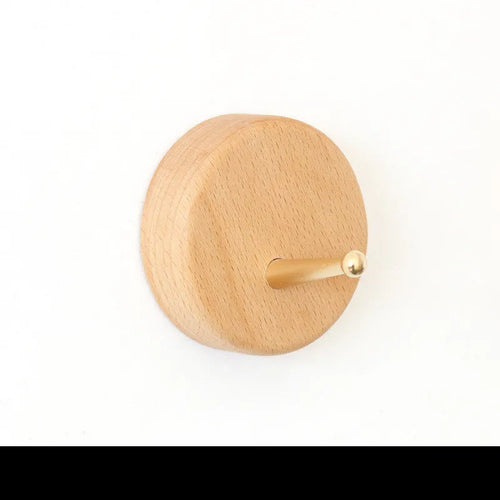 Beech wood adhesive wall hook with brass finish in capsule shape, shown next to round, oval, diamond and square variants.
