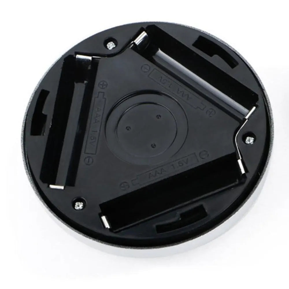 Silver wireless motion sensor night light on a table, showing its compact 80mm size.