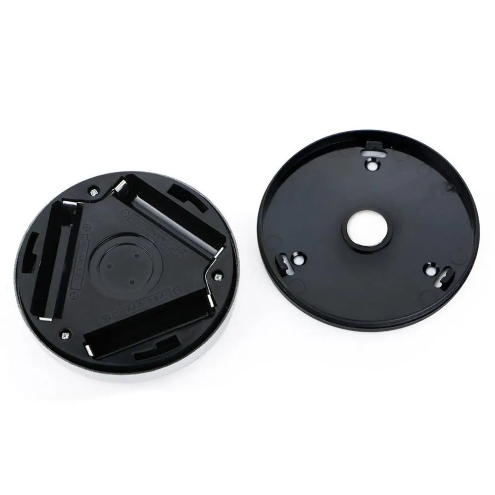 Silver wireless motion sensor night light on a table, showing its compact 80mm size.
