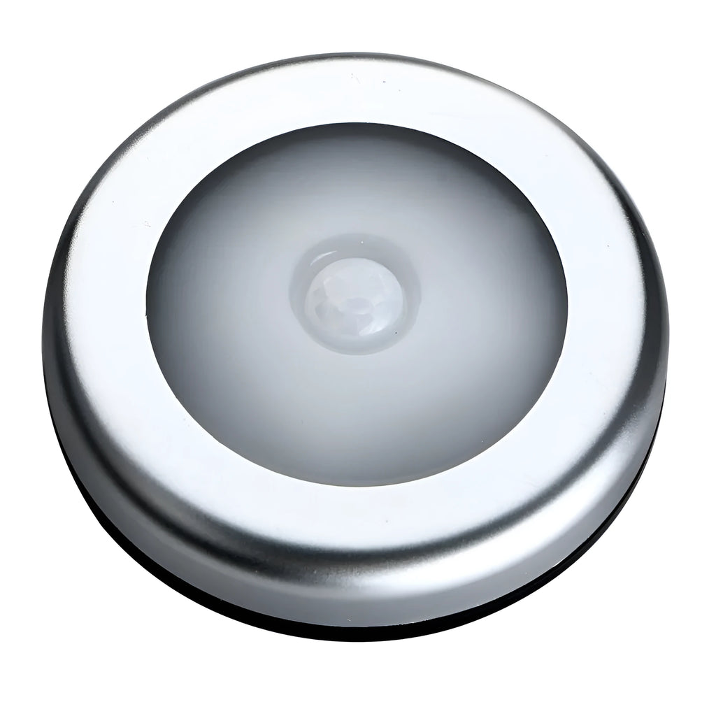 Silver wireless motion sensor night light on a table, showing its compact 80mm size.