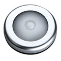 Silver wireless motion sensor night light on a table, showing its compact 80mm size.