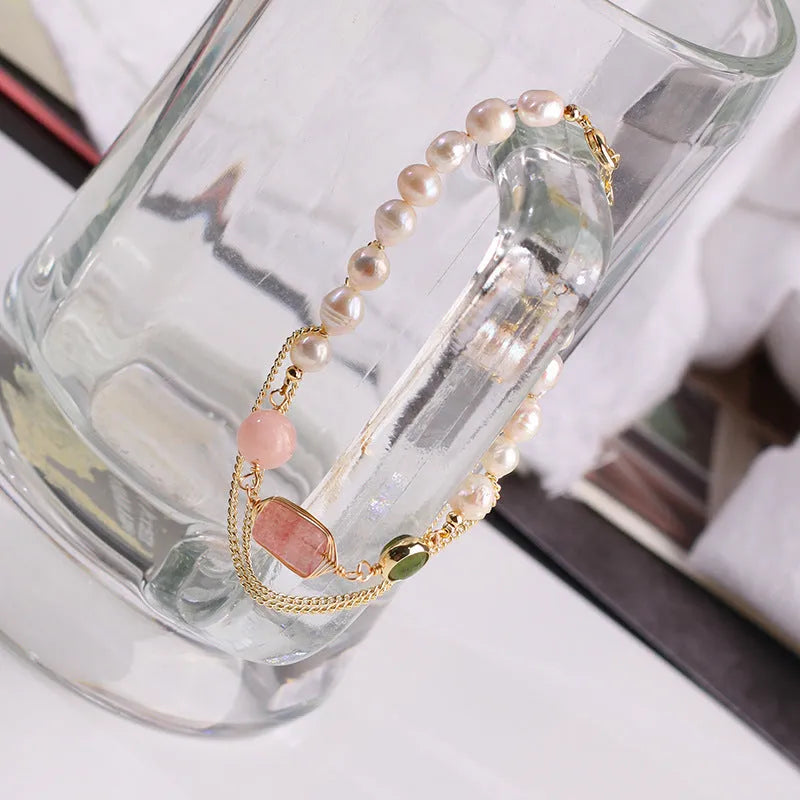 Pink freshwater pearl bracelet with geometric strawberry crystal charms on wrist
