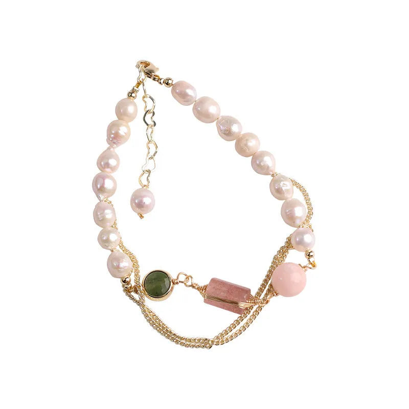 Pink freshwater pearl bracelet with geometric strawberry crystal charms on wrist