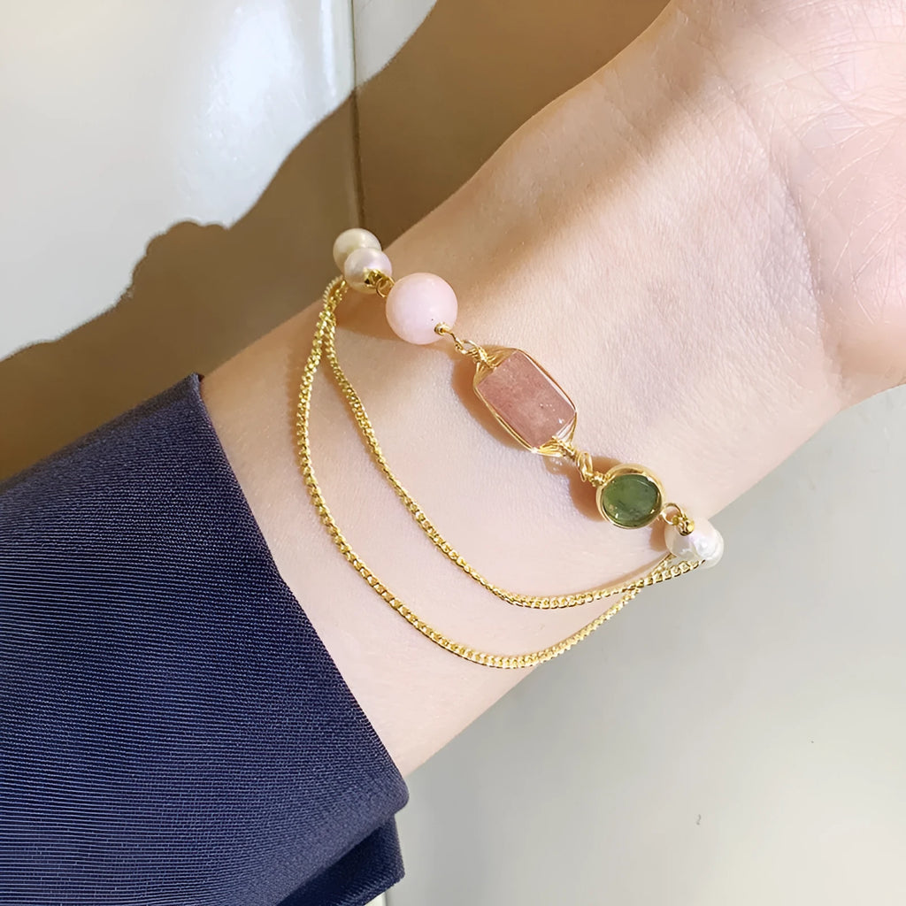 Pink freshwater pearl bracelet with geometric strawberry crystal charms on wrist