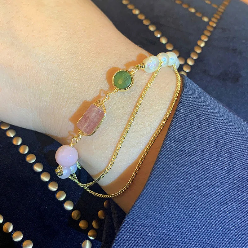 Pink freshwater pearl bracelet with geometric strawberry crystal charms on wrist