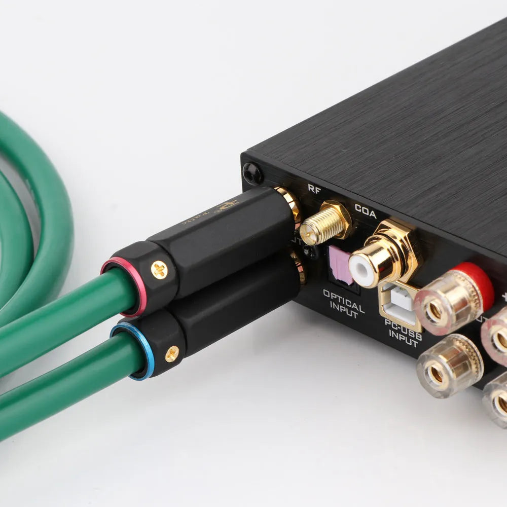 Silver audiophile RCA audio cable with lotus plugs, showing 4-core shielded construction.