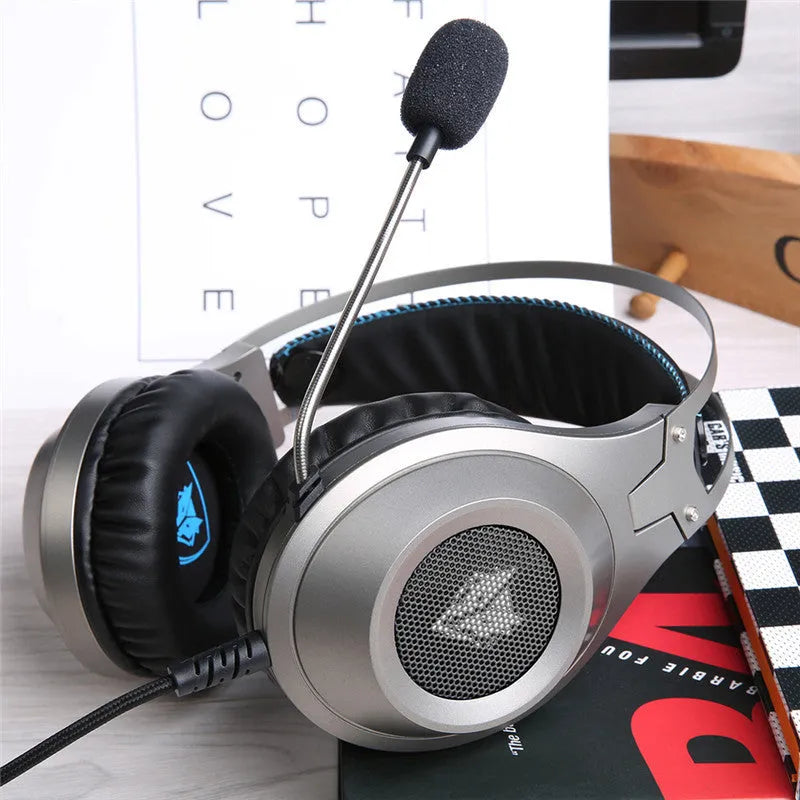 Black wired USB computer headset with over-ear cups and an integrated microphone on a PC desk.