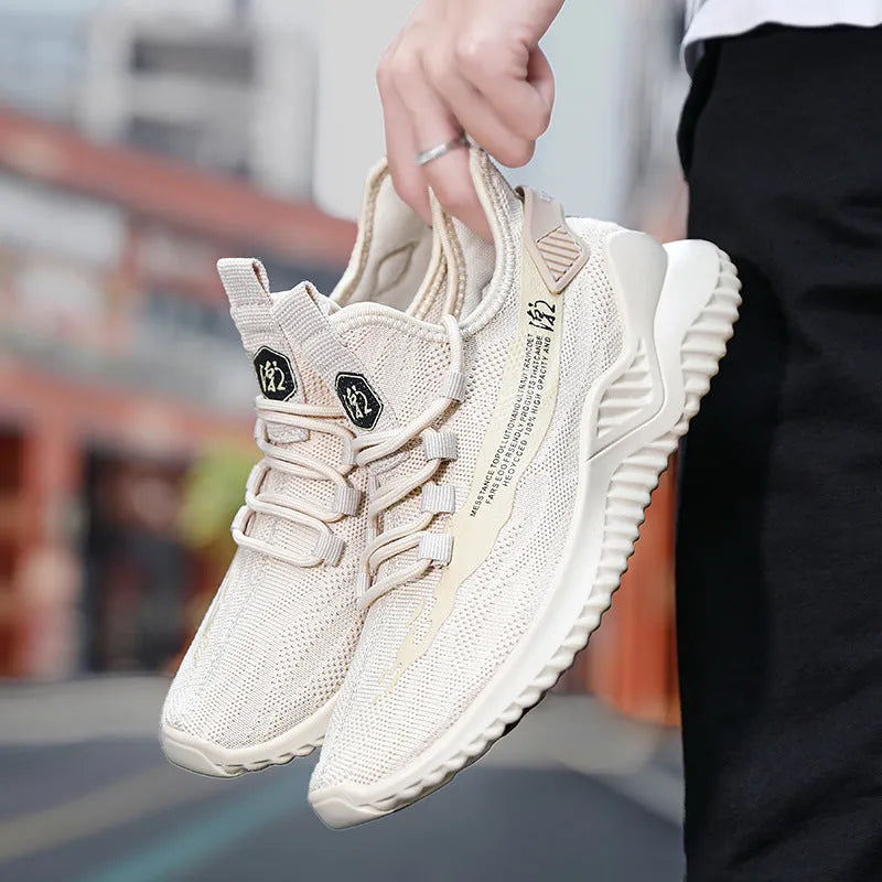 Men's white mesh sports trainers with round toe and rubber sole on neutral background