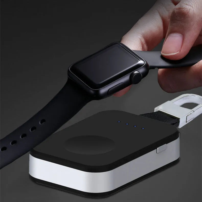 Black Apple Watch keychain wireless power bank with 1000mAh battery next to an Apple Watch.