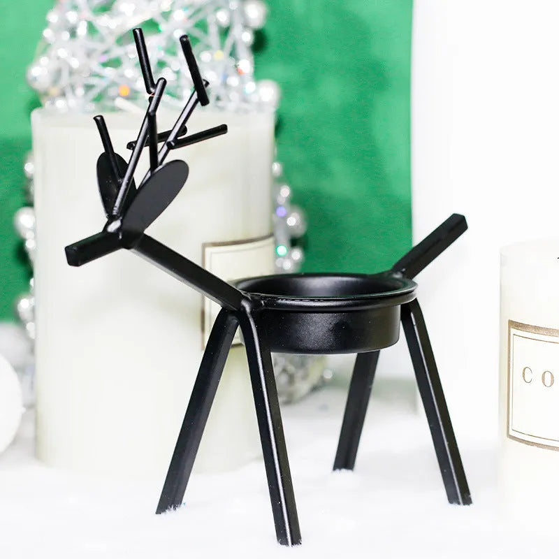 Black iron Christmas candlestick holder with decorative elk antler design.