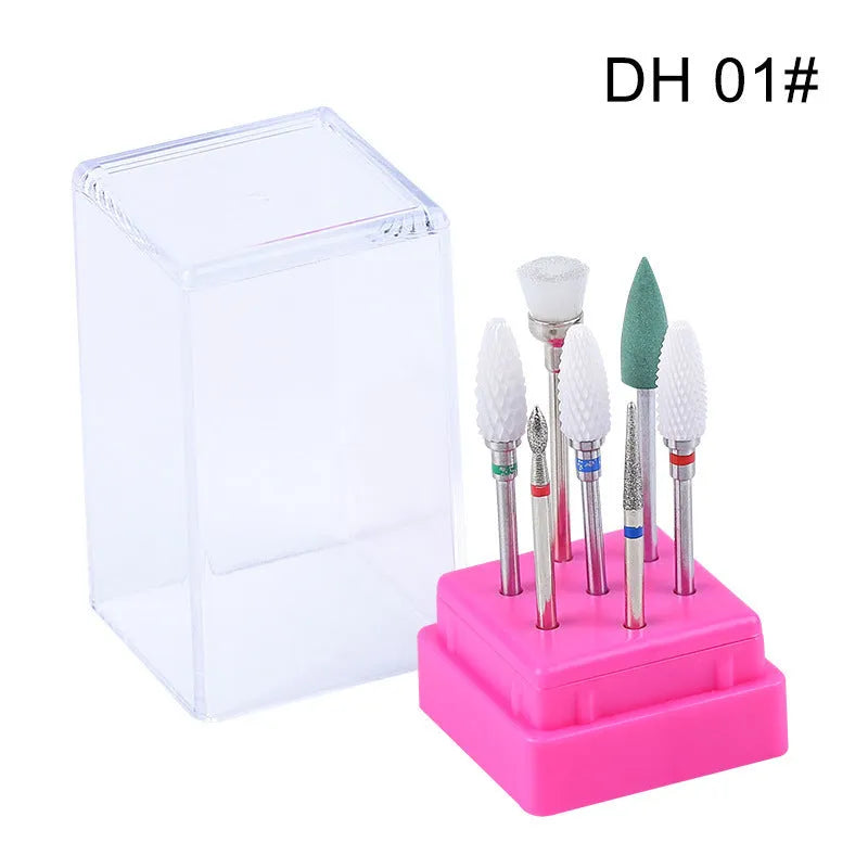 Set of seven tungsten steel nail drill bits and a brush in a clear plastic case.