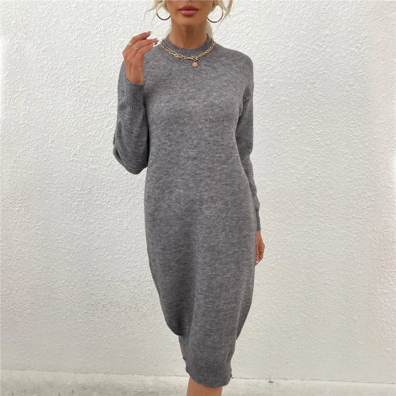Women's grey crew neck long sleeve acrylic sweater dress on a hanger.