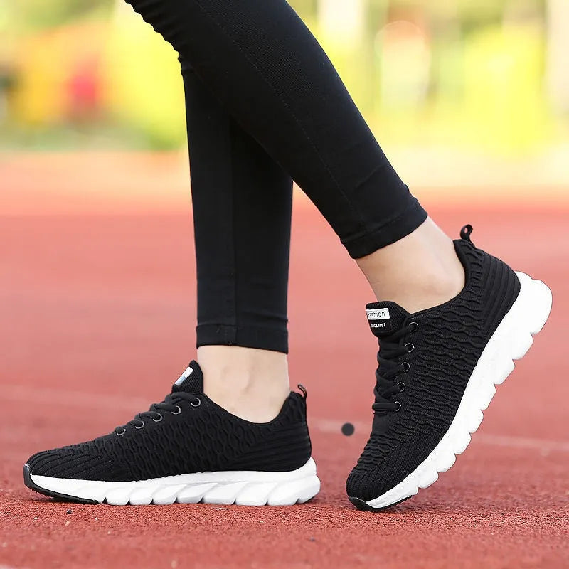 Women's running shoes with fly weaving upper in black, pink, or white colours.