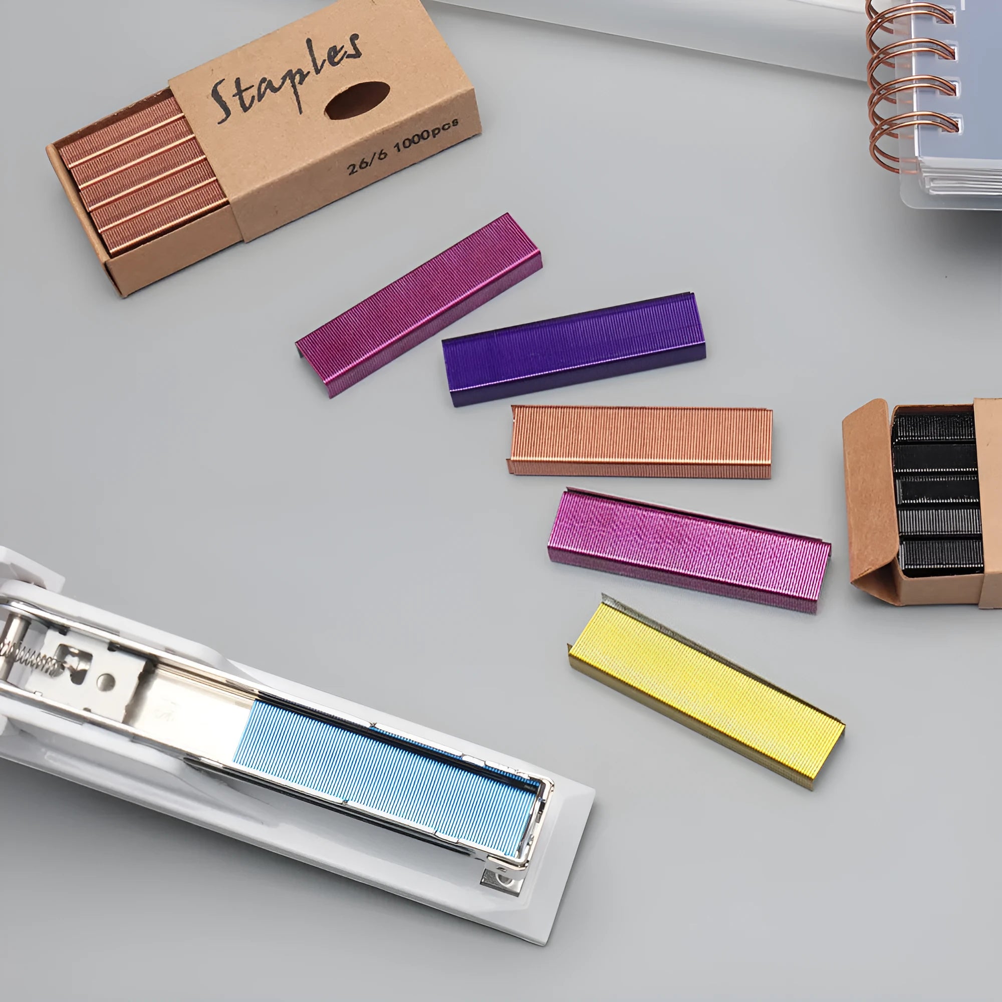 Box of 1000 metal office staples in black purple rose gold and rose red colours