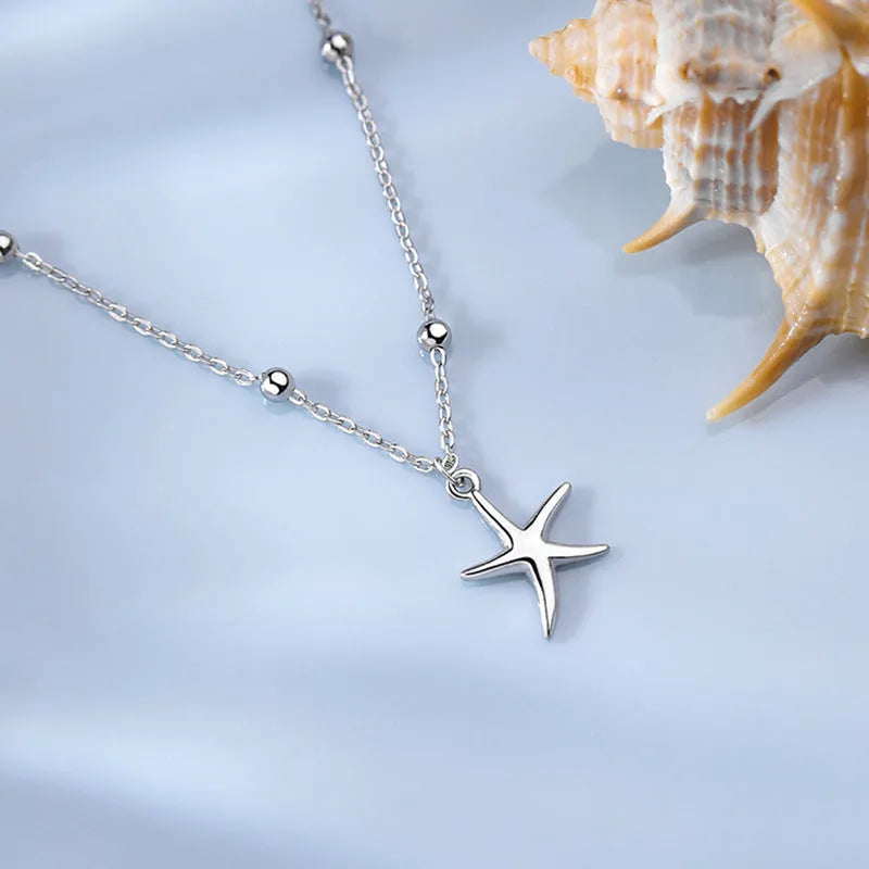 Sterling silver anklet with round beads and small starfish charm on ankle