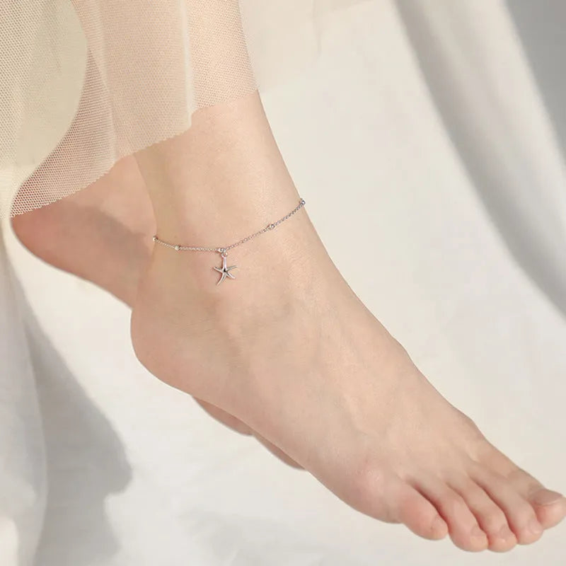 Sterling silver anklet with round beads and small starfish charm on ankle