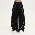 Black pleated hip hop trousers with wide-leg design and stripe pattern