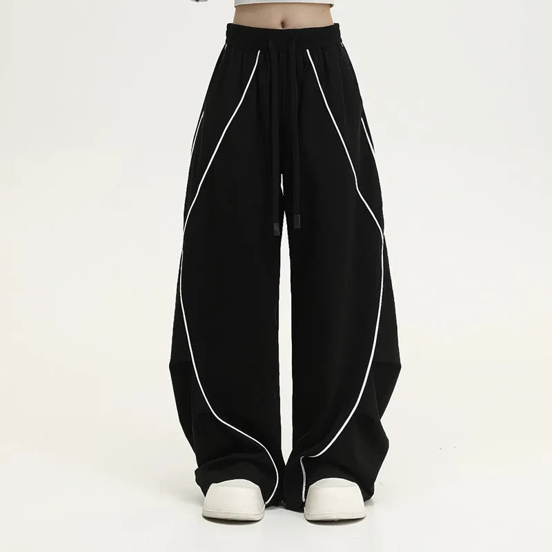 Black pleated hip hop trousers with wide-leg design and stripe pattern