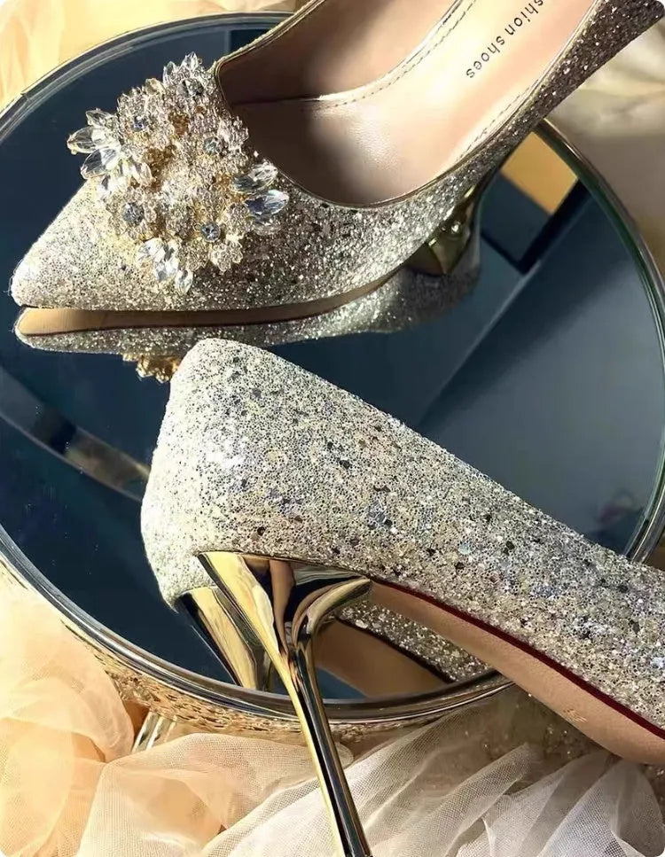 Champagne pointed-toe women's bridal shoes with floral rhinestone detail on a white background