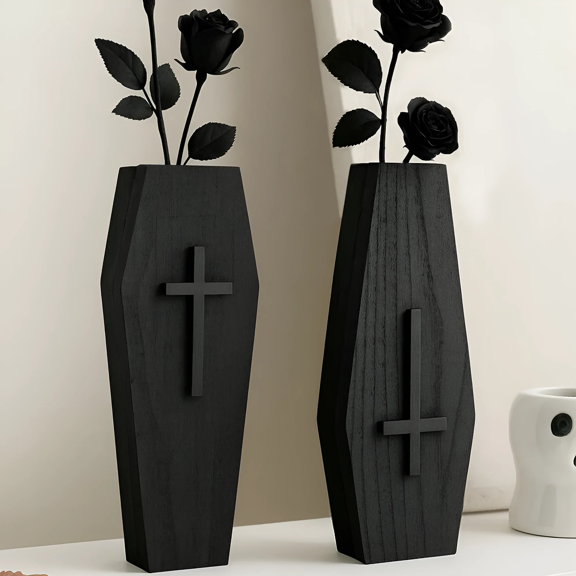 Black wooden cross-shaped wall shelf with a small ledge, measuring 27cm tall.