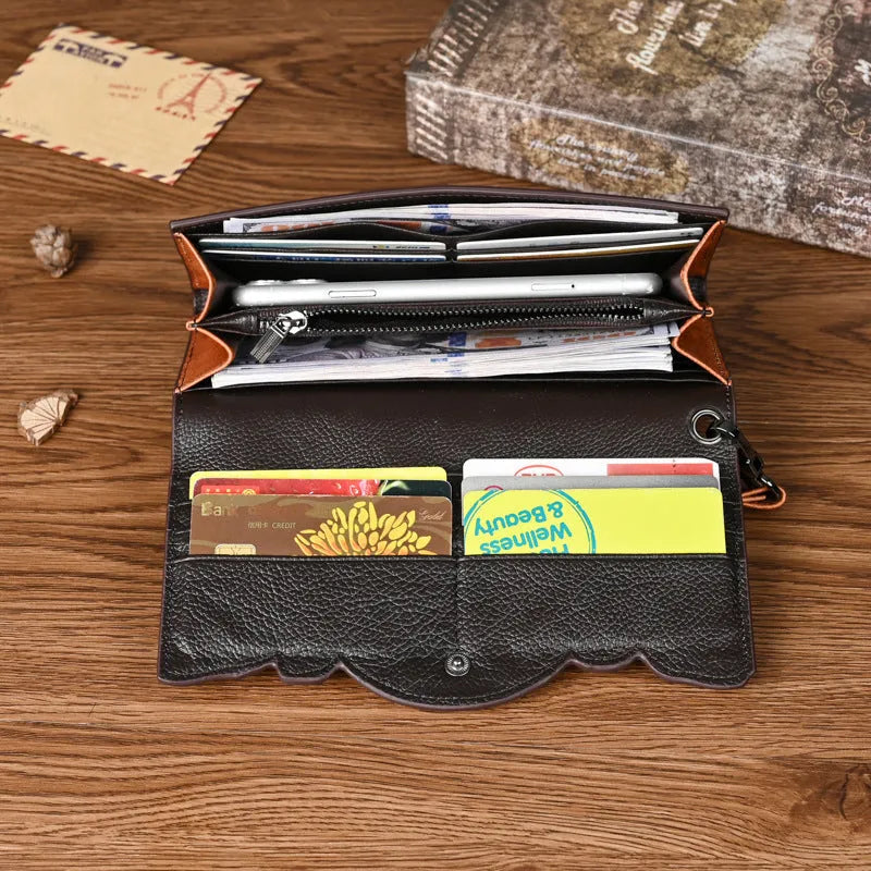Retro brown floral embossed tri-fold leather wallet open to show interior compartments.