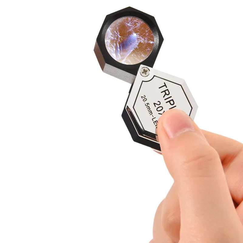 Handheld jeweller's loupe with metal frame and optical glass lenses for 10x to 30x magnification