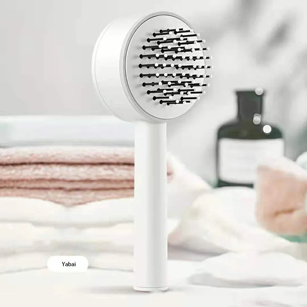 One-key self-cleaning hair brush with green airbag massage comb and non-slip handle on white background
