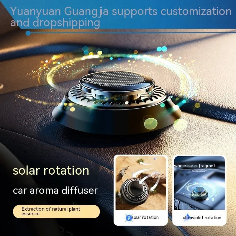Solar-powered kinetic car air freshener with rotating double rings on a car dashboard.