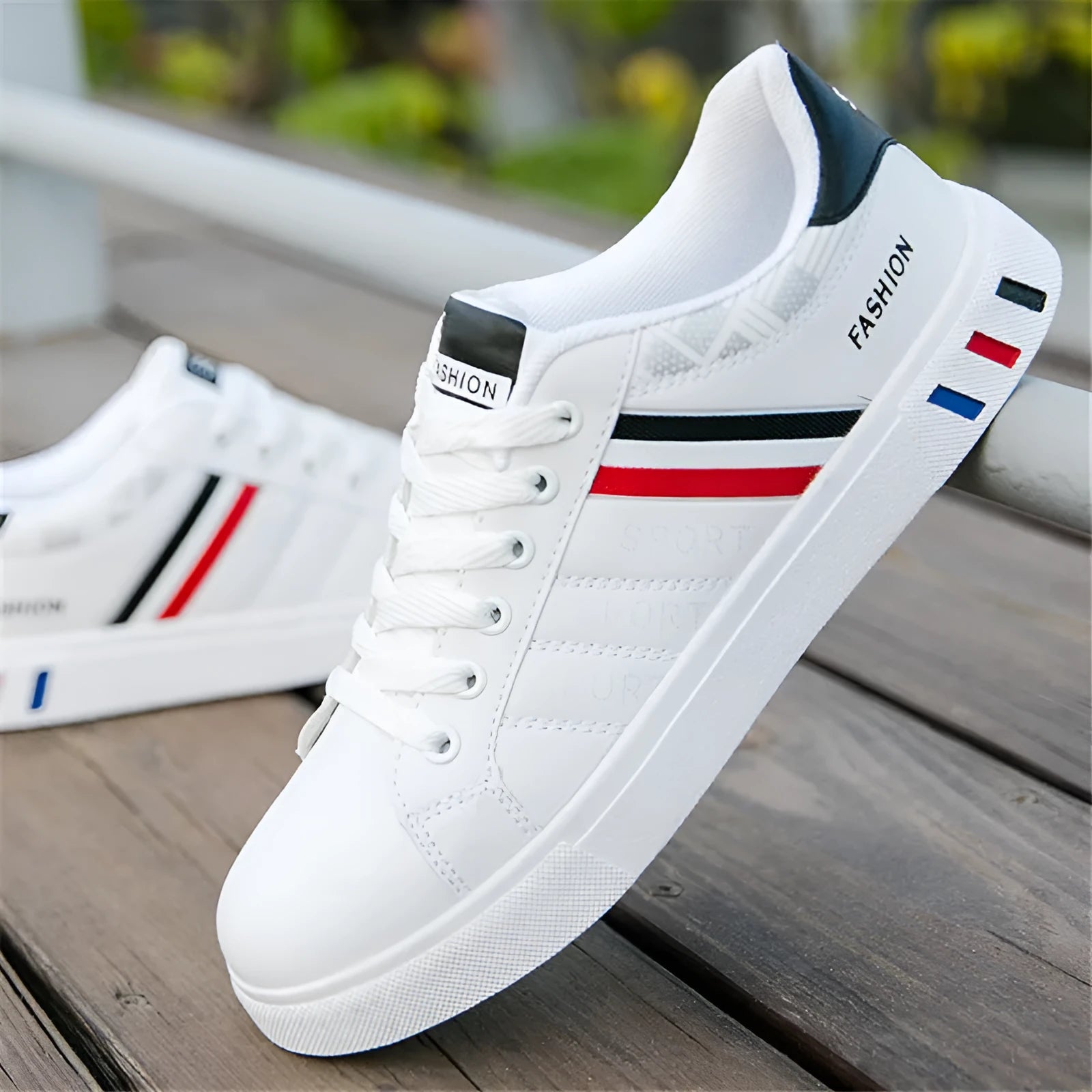 A pair of neutral-coloured sports shoes on a white background, shown in black, grey and white colour options.