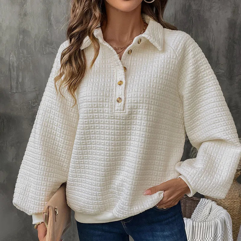 Women's beige textured polo collar long sleeve sweater laid flat.
