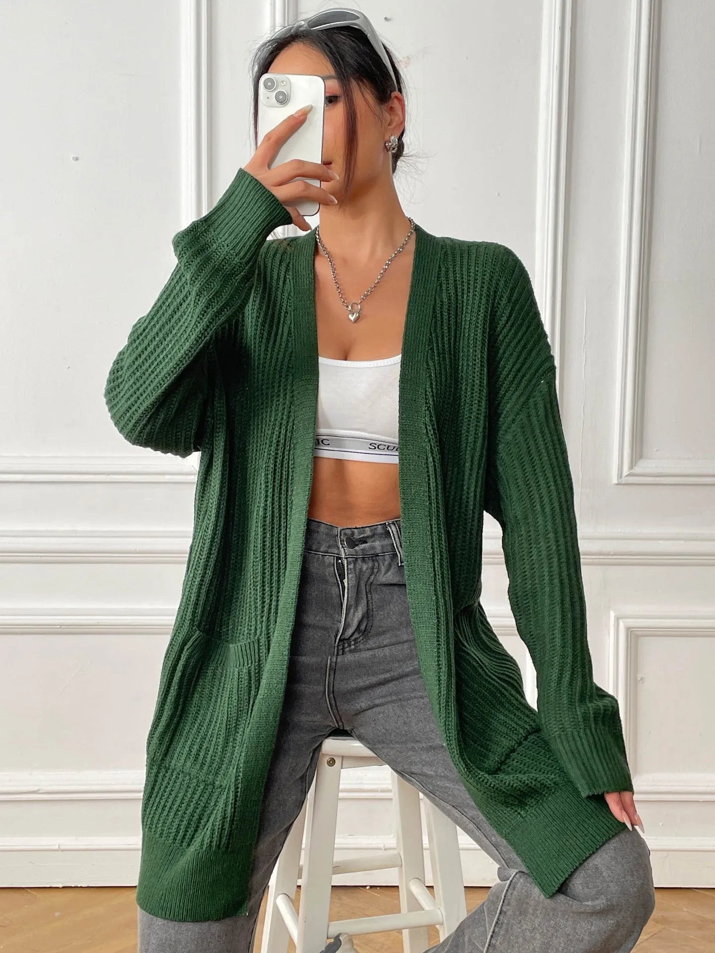 Women's double pocket casual cardigan sweater in dark green, loose mid-length fit.