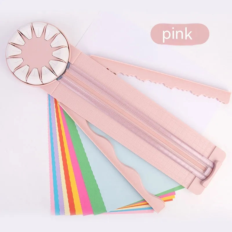 Plastic paper cutting machine with 12 multifunctional heads in pink colour on craft table