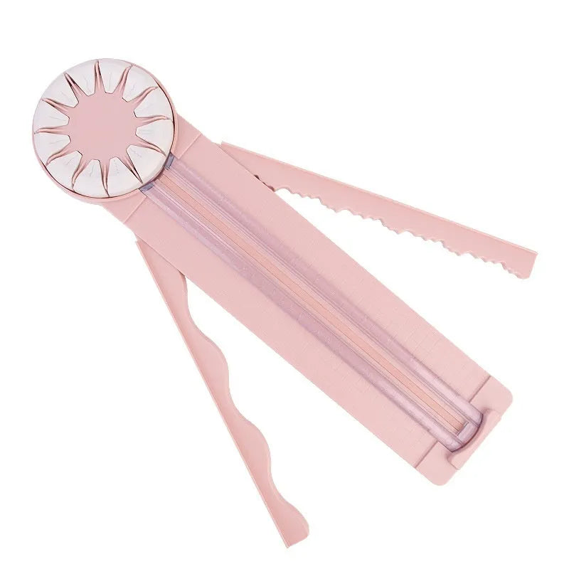 Plastic paper cutting machine with 12 multifunctional heads in pink colour on craft table