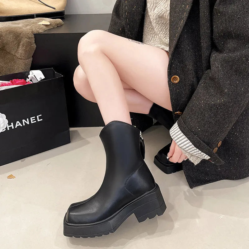 Black and brown platform Martin boots with square toe, high heel, and back zipper closure.