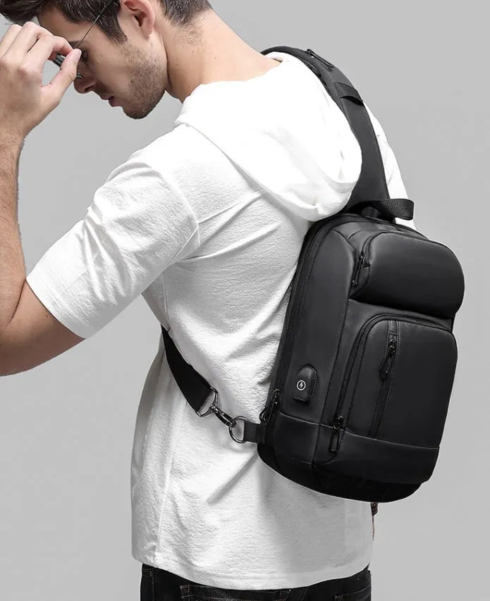 Black PVC outdoor shoulder bag with air cushion strap and multiple compartments