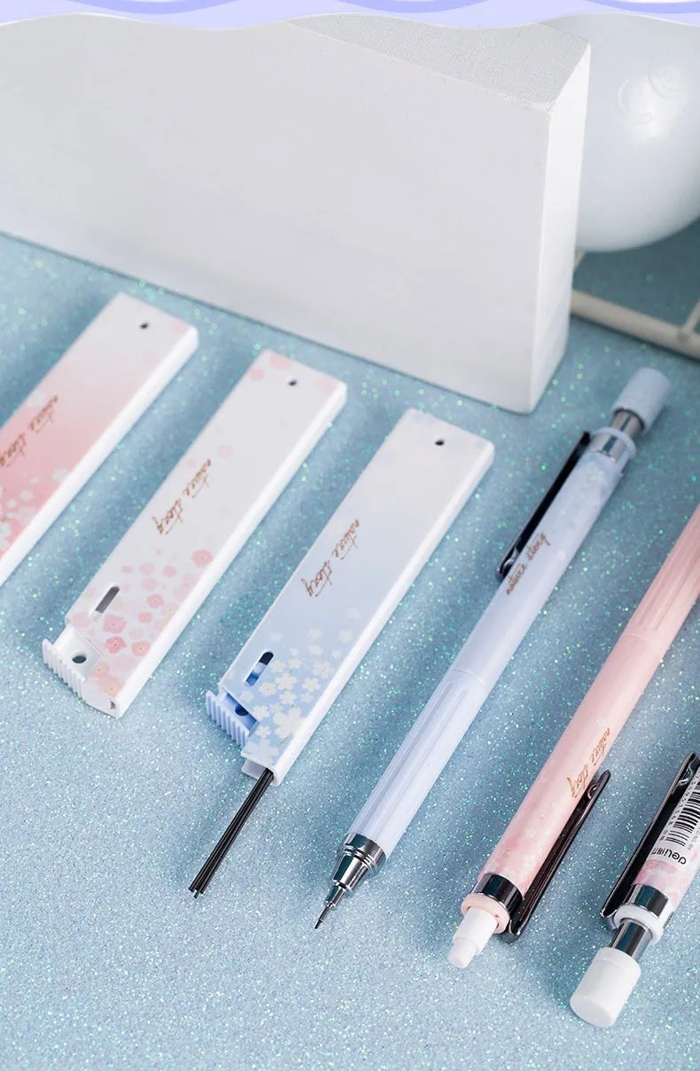 Three Sakura-design automatic pencils with mixed colours and 0.5mm HB refill boxes