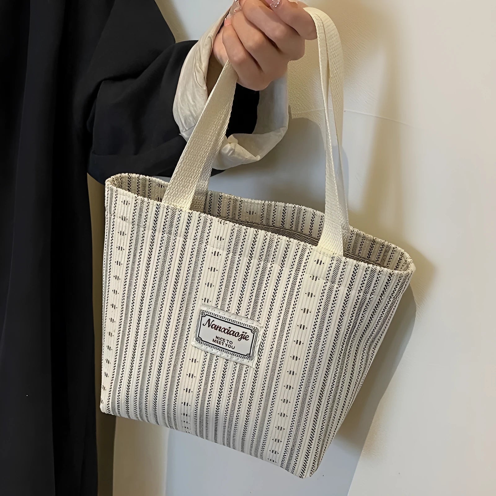 Japanese style corduroy handbag in dark brown showing textured fabric and minimalist design.